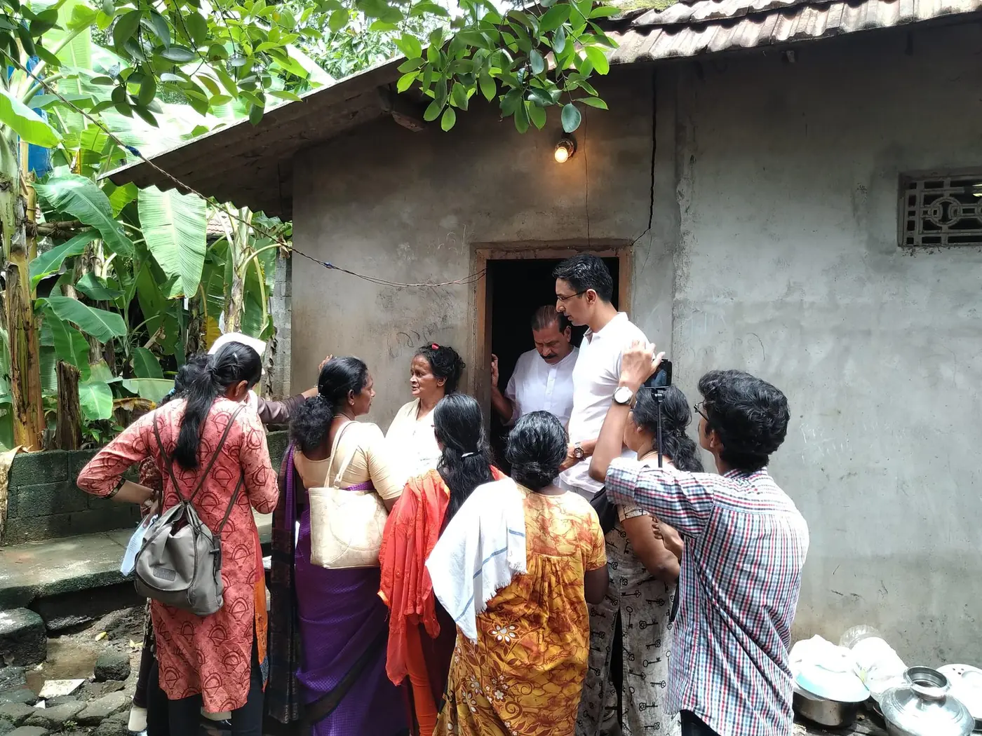 Project Happiness team and Kudumbashree members visiting an elderly woman at her home