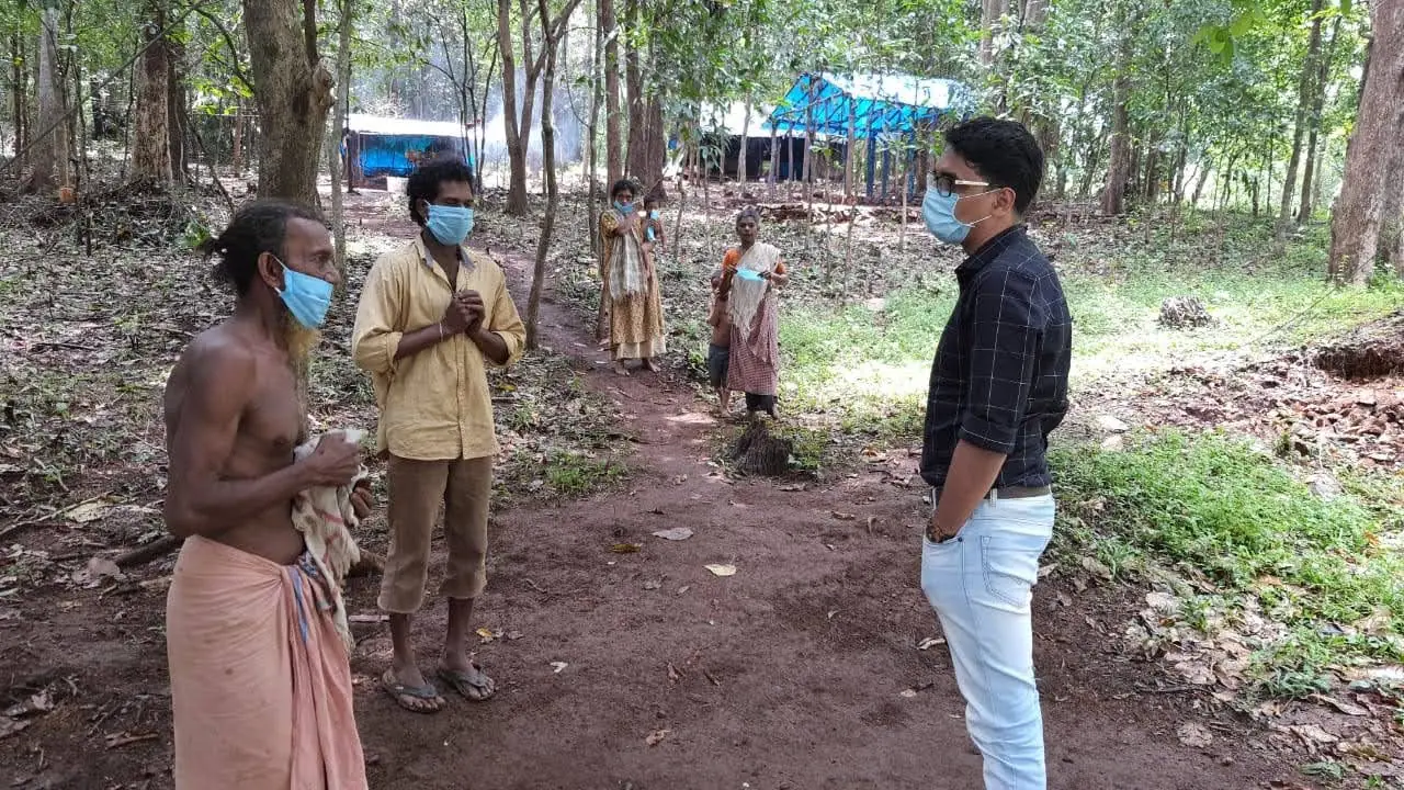 Blessan Kurien Thomas meeting members of a tribal settlement during a field visit